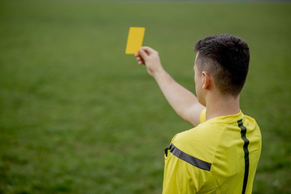 referee showing yellow card in Volleyball